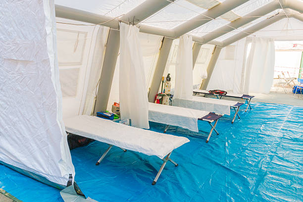 white rescue control centre tent with camp bed white rescue control centre tent with camp bed and Emergency equipment temporary stock pictures, royalty-free photos & images