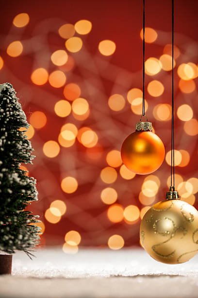 istock Red Christmas Bokeh Lights, hanging Baubles and Snow 517470835