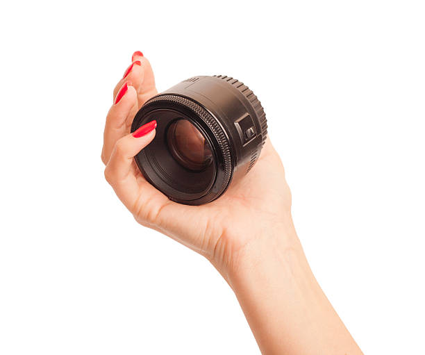istock Female Hand Holding a camera lens 517482319