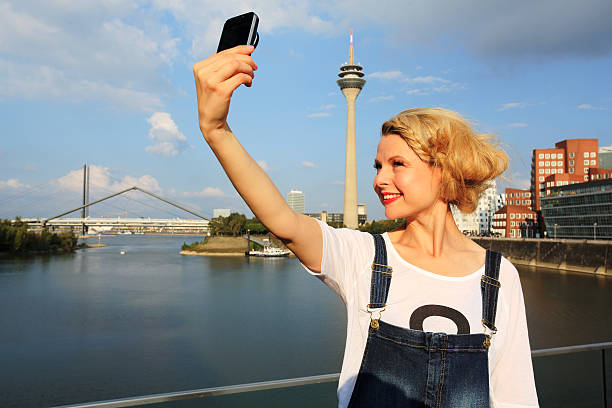 young woman taking a selfie in Dusseldorf stock photo