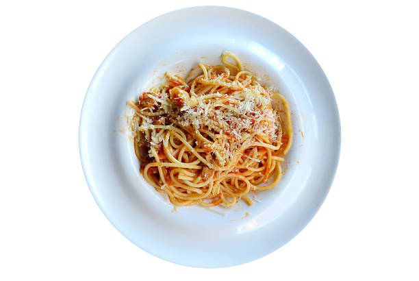 istock Big plate with pasta spaghetti bolognese isolated on white 517483657