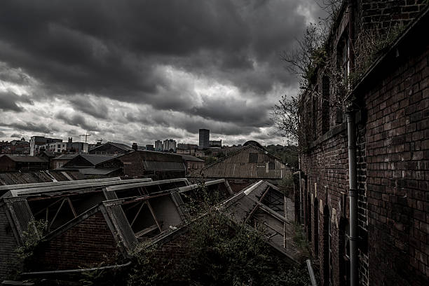 istock Stormy skies over abandoned derelict works 517484285