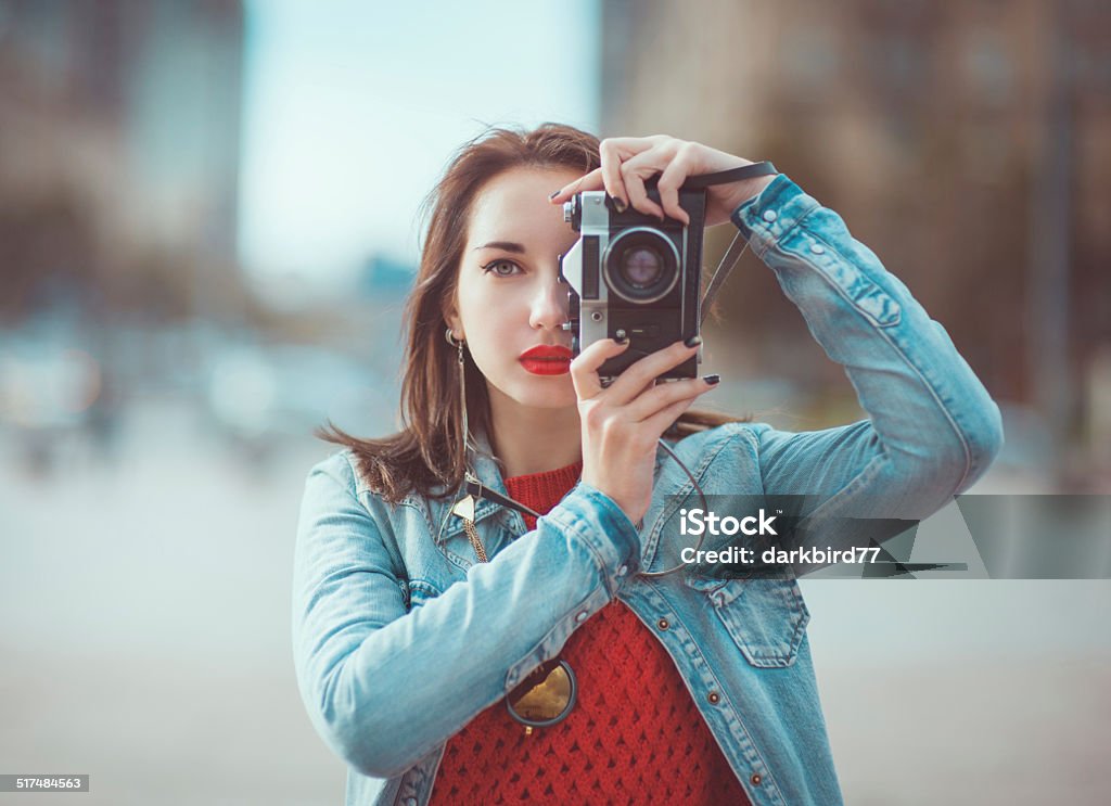 Hipster girl with retro camera Young beautiful hipster girl with retro camera in the city Adult Stock Photo