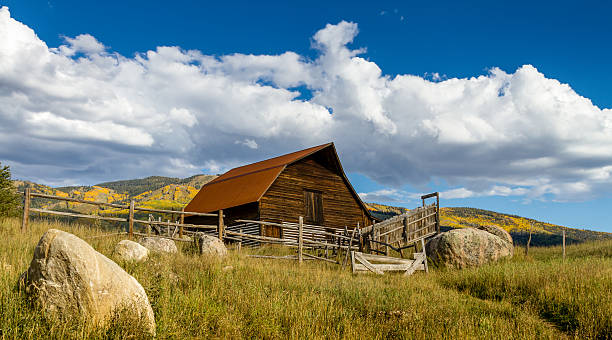 Fall in Steamboat Springs Colorado Historic Moore Barn in Steamboat Springs Colorado with mountain slopes filled with fall color on warm autumn afternoon steamboat springs photos stock pictures, royalty-free photos & images