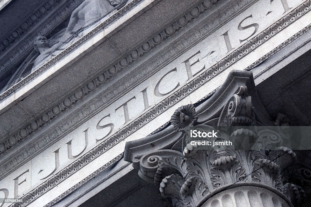 Courthouse close with Justice inscribed Legal System Stock Photo