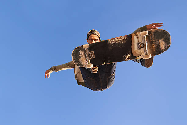 Have you see skills like this? A young man doing tricks on his skateboard at the skate park x games stock pictures, royalty-free photos & images