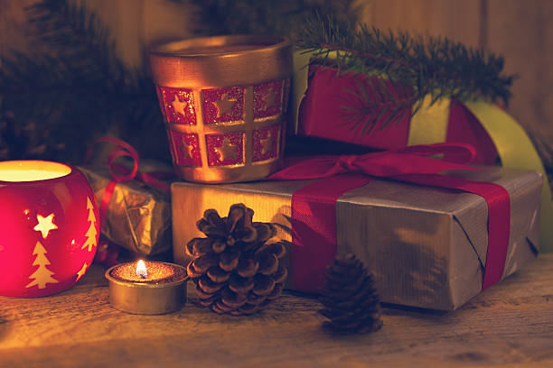 istock Christmas decoration with candles, pine cones and presents 517486387