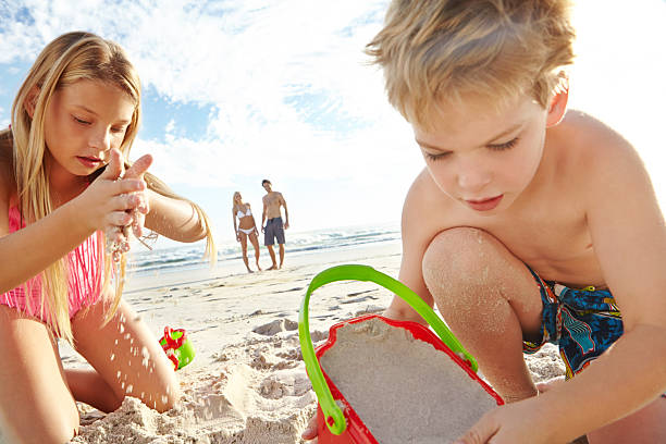 istock Hard at work building the perfect sandcastle 517486909