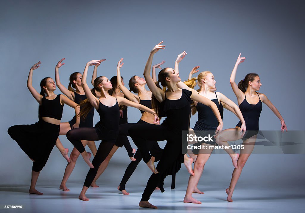 The group of modern ballet dancers The group of modern ballet dancers dancing on gray background Dancing Stock Photo