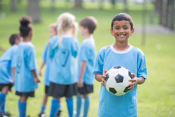istock Little Boy Holding a Soccer Ball 517488120