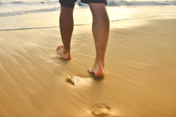 istock Young man walking on the beach 517488487