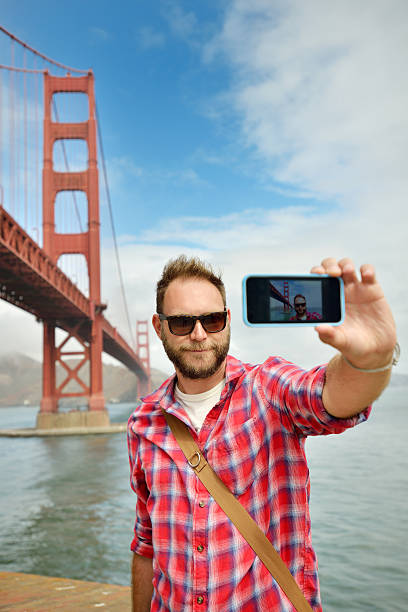 istock Young man making a selfie with the Golden Gate 517488511