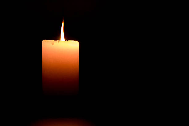 istock candle flame is lit in the dark 517488644
