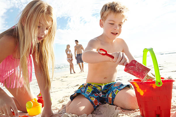 istock Enjoying a day at the beach with his sister 517488787