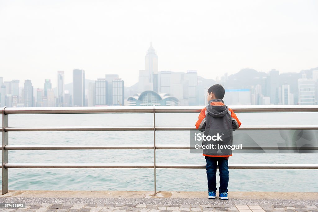 kd stand by  the handrail watching cityscape kid stand by  the handrail watching cityscape Asian and Indian Ethnicities Stock Photo