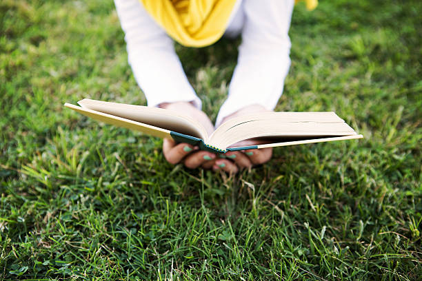Person is Reading a Book in Nature
