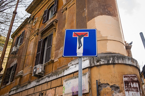 Rome, Italy - 27 February 2016:  Colour image of a no-through-road sign in the Trastevere region of Rome, Italy, adapted to resemble the crucification of Christ.