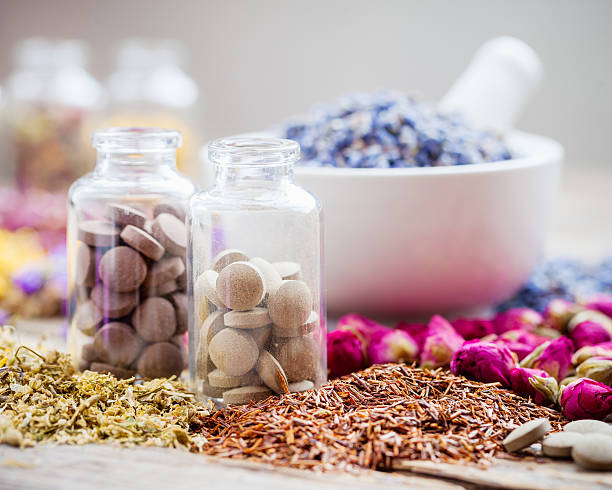 istock Bottles of tablets, healing herbs and mortar with dry lavender 517492088