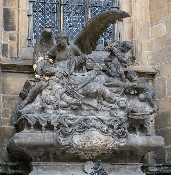 Sculpture of St. John of Nepomuk Cenotaph at Metropolitan Cathedral of Saints Vitus, Wenceslaus and Adalbert in Prague, Czech Republic. Gothic architecture
