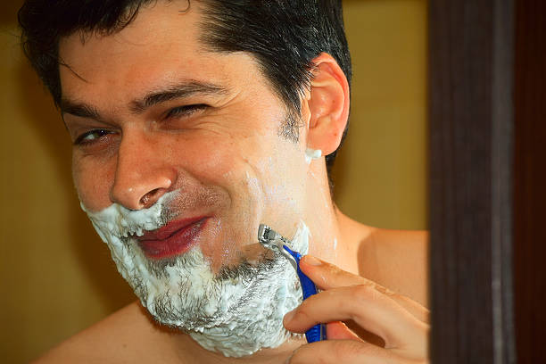 istock close up of a young man shaving 517494158