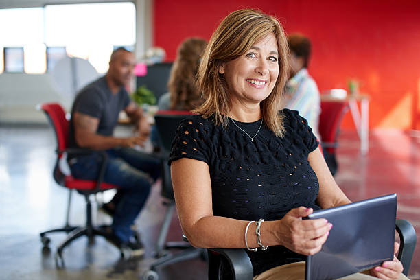 istock Confident female designer working on a digital tablet in red 517494772