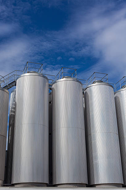istock Giant industrial tanks on the bright blue sky 517496266