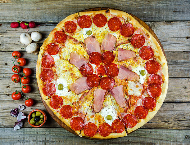 istock Pizza with decoration on a wooden board 517498102
