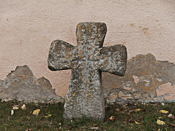istock Cross at the cemetery wall 517498165