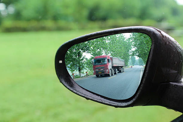 istock big truck reflected in rear mirror 517498387