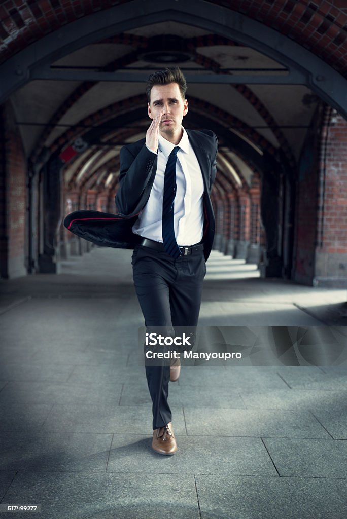 Businessman hurrying to work Businessman hurrying to work, wearing a gray suit and brown shoes. He runs because he is late Running Stock Photo