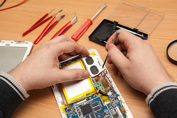 istock Master repairs the tablet computer. Top view of hands working. 517499358