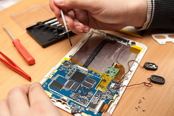 istock Master repairs the tablet computer. Top view of hands working. 517499658