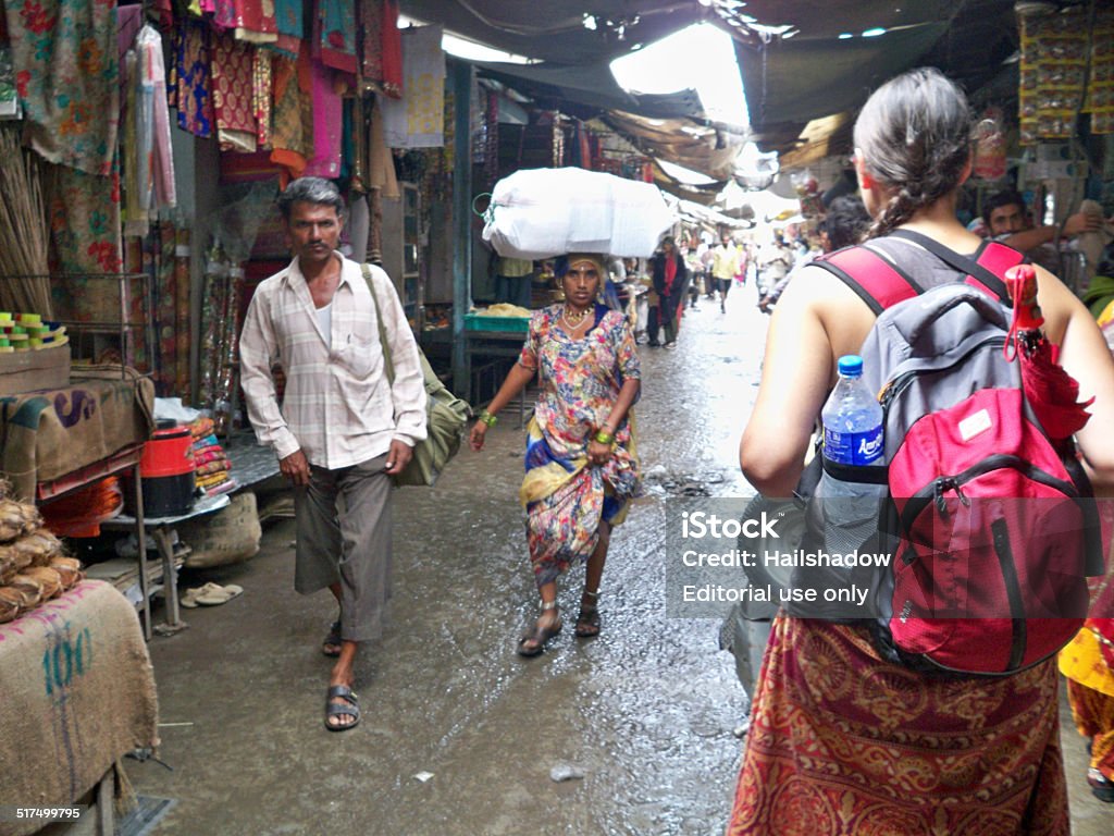 woman carrying a big bag on her head Jodhpur, India - January 6, 2008: Woman carrying a big bag on her head in the busy street of Jodhpur. Adult Stock Photo