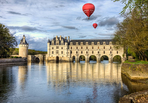 Chenonceau Castle Chenonceaux, France- April 6, 2014: Two red hot air balloons fly above the Chenonceau Castle spanning the river Cher in the Loire Valley ,France. loire valley photos stock pictures, royalty-free photos & images