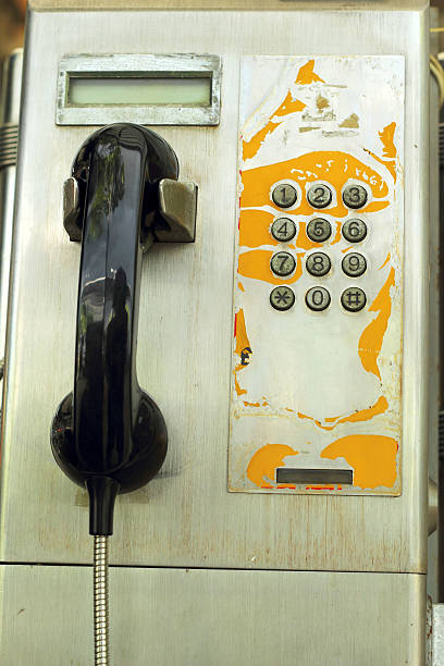 istock hand  and old vintage phone booth. 517500959