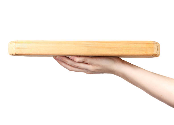 istock female hand holding a cutting board on a white background 517501392