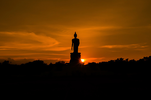 Silhouette Buddha with sunset background, Thailand