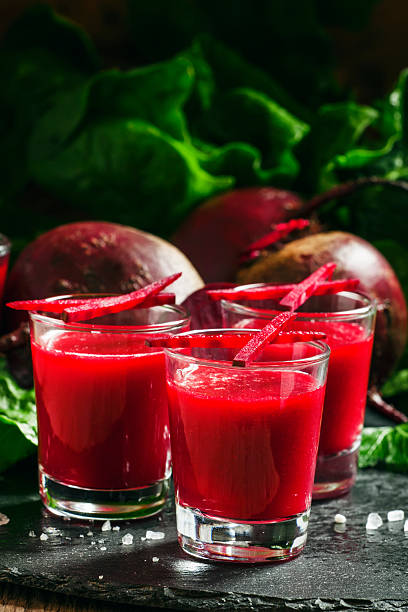 istock Beetroot juice in glasses on a dark background 517502472