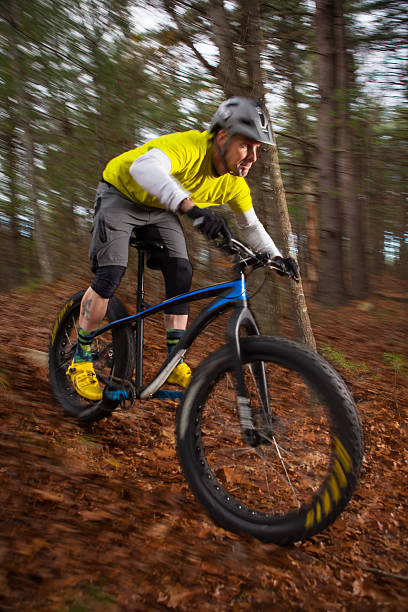 istock Mountain biker descending a trail at speed in the woods 517502684