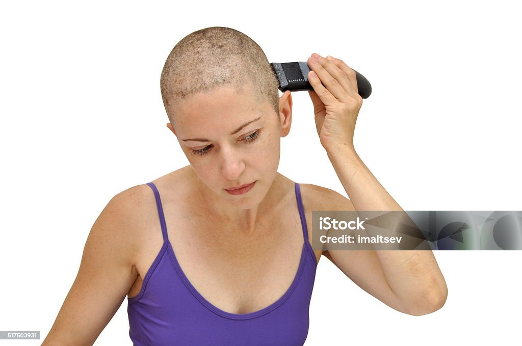 Shaving left Woman in purple bodice shaving herself bald using left hand, isolated on white. Shaving Stock Photo