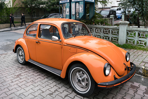 İstanbul, Turkey - March 25, 2016:Orange vintage antique Volkswagen Beetle is sitting in a parking in istanbul.Old style car but still very trendy.