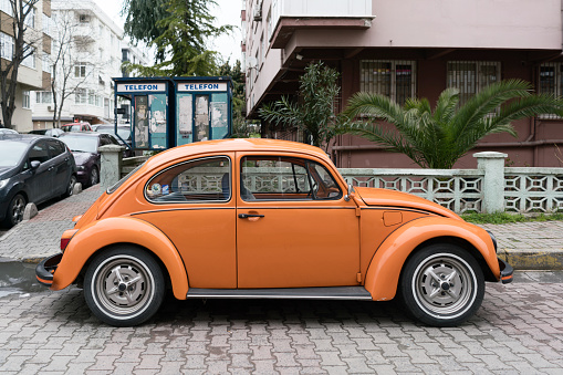İstanbul, Turkey - March 25, 2016:Orange vintage antique Volkswagen Beetle is sitting in a parking in istanbul.Old style car but still very trendy.