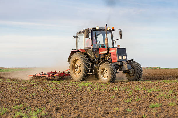 istock Farmer cultivating arable land before seeding 517511762