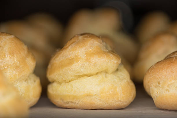 istock Baked Pate a Choux on Parchment Paper 517512696