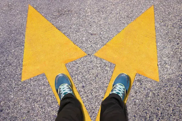 Photo of Feet and words Work and Life  painted on road