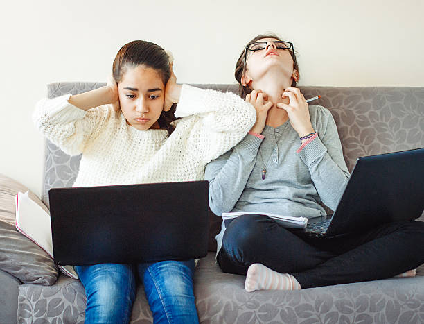 Two girls students unhappy with homework Two girls students unhappy with homework boring homework twelve stock pictures, royalty-free photos & images