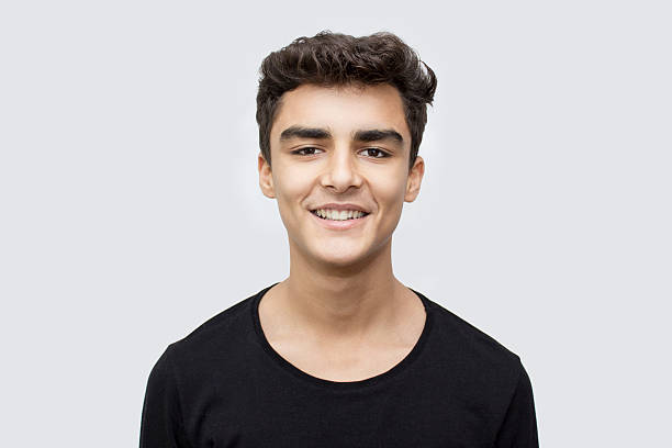 istock Portrait of smiling boy over gray background 517515280