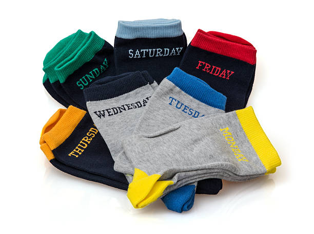 Isolated funny wool socks with days inscriptions stock photo