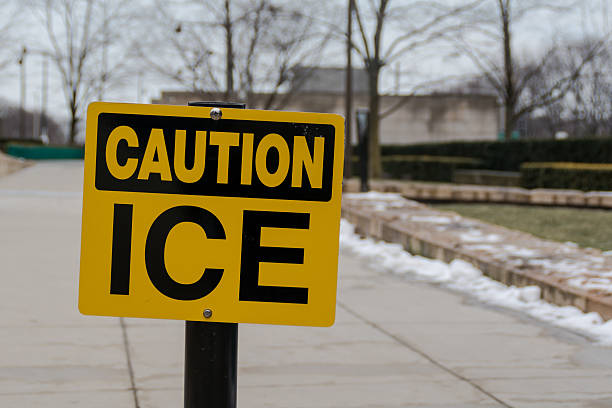 istock Yellow and black sign with caution ice text in winter 517516546