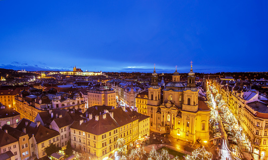 Night view over Prague and the St. Nicholas Church (Malá Strana)  beautiful illuminated during Christmas season.